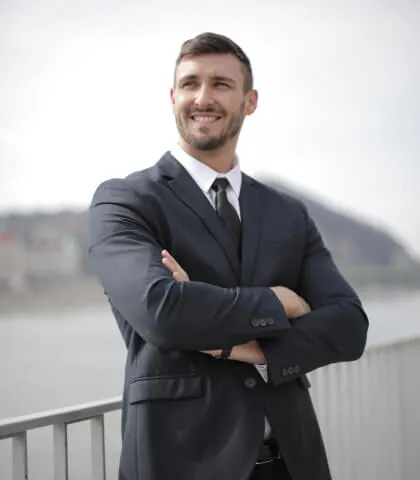Man in a tailored suit wearing classic accessories