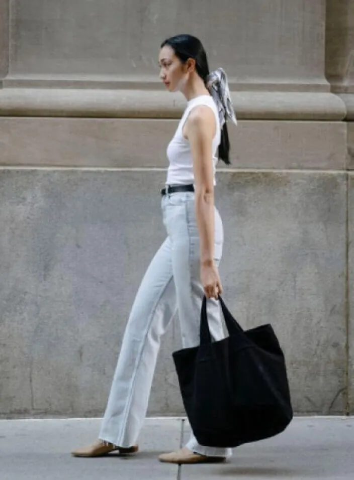 Woman with a tote bag walking in the city